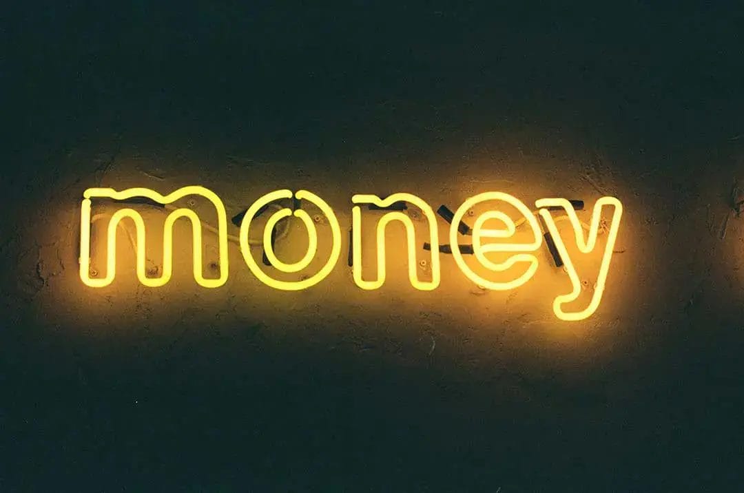 Glowing neon sign spells 'money'.